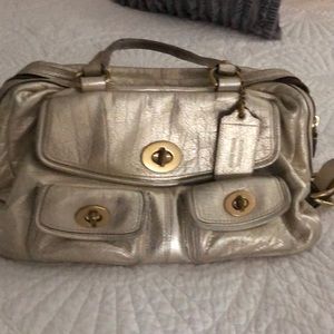 Gold Coach bag for everyday wear.